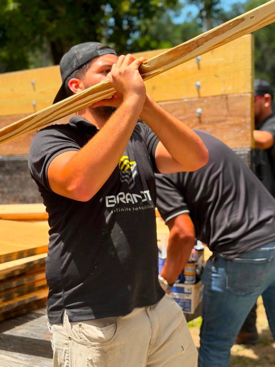 Team member carrying materials on a job site
